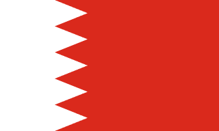 The flag of Bahrain has a red field. On the hoist side, it features a white vertical band that spans about one-third the width of the field and is separated from the rest of the field by five adjoining fly-side pointing white isosceles triangles that serve as a serrated line.