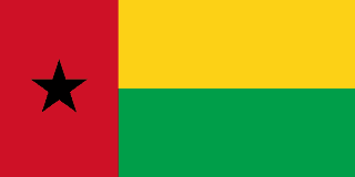 The flag of Guinea-Bissau features a red vertical band on its hoist side that takes up about two-fifth the width of the field, and two equal horizontal bands of yellow and green adjoining the vertical band. A five-pointed black star is centered in the vertical band.