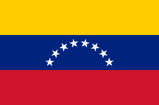 The flag of Venezuela is composed of three equal horizontal bands of yellow, blue and red. At the center of the blue band are eight five-pointed white stars arranged in a horizontal arc.